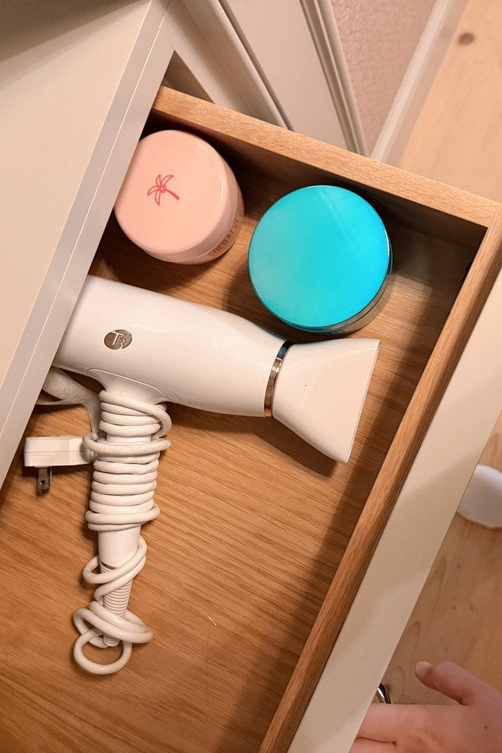 A drawer with the hairdryer already in it