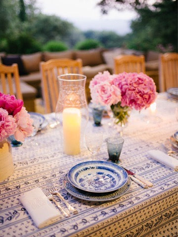 Setting the table outside at dusk, the hills behind