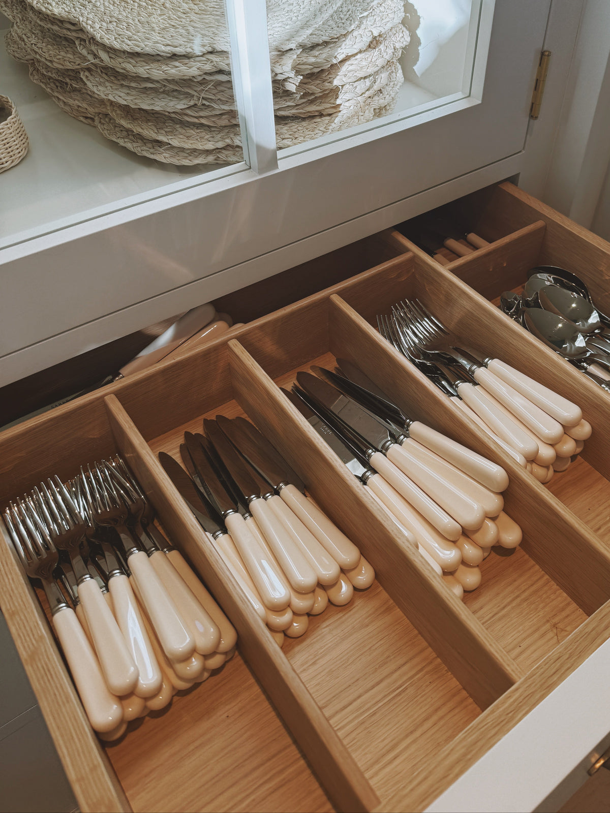 A drawer of bone-handled knives, forks and spoons, sorted