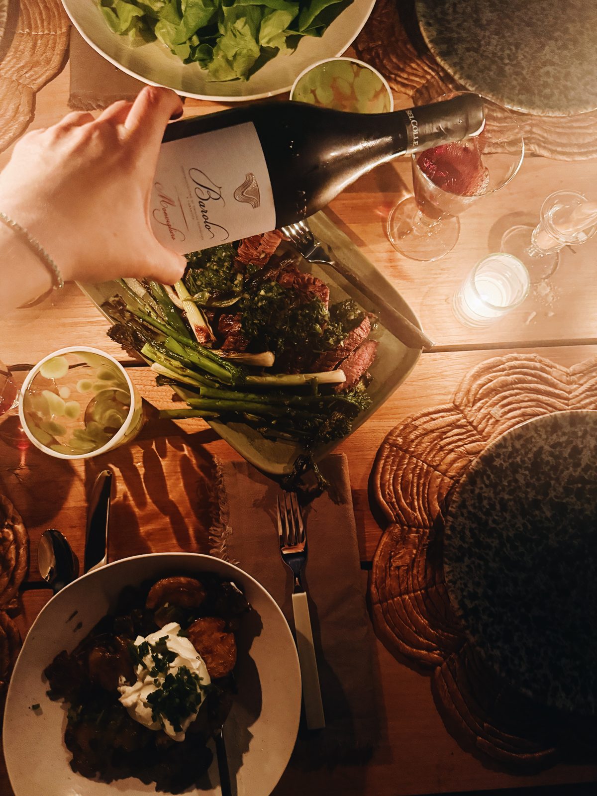 Pouring a bottle of Barolo over the dinner table