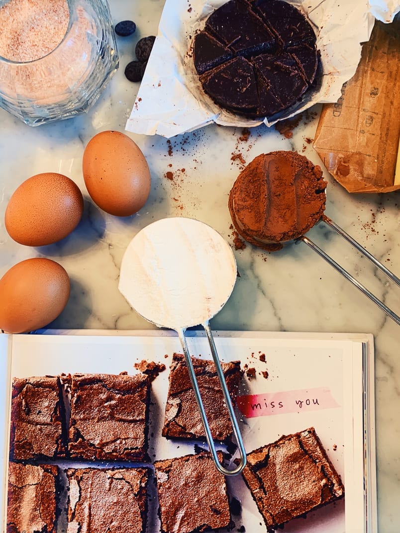 Brownies, eggs and a chocolate cake on a marble counter