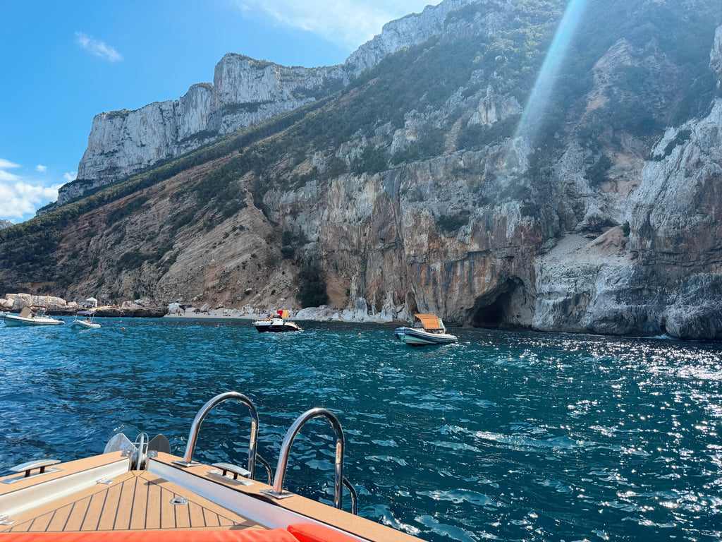 Clear water below the cliffs, from the back of the boat