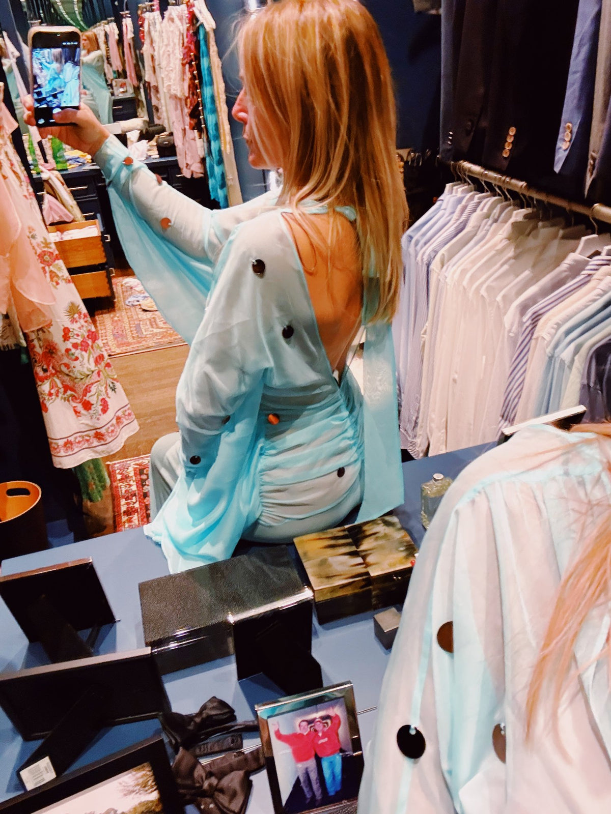 Shopping a rail of printed shirts