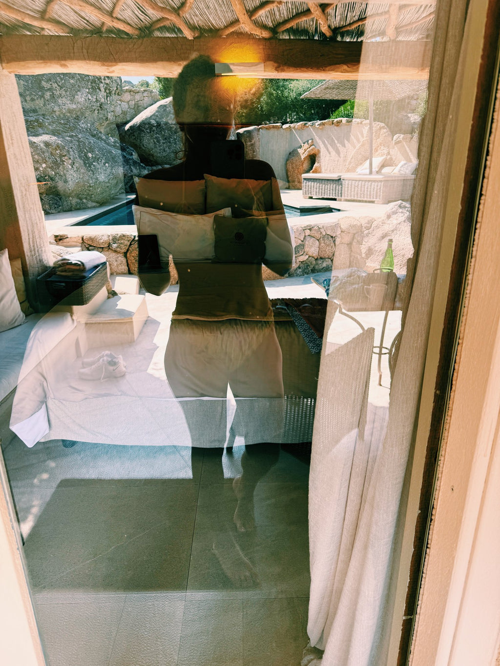 A mirror reflection in a white hotel room