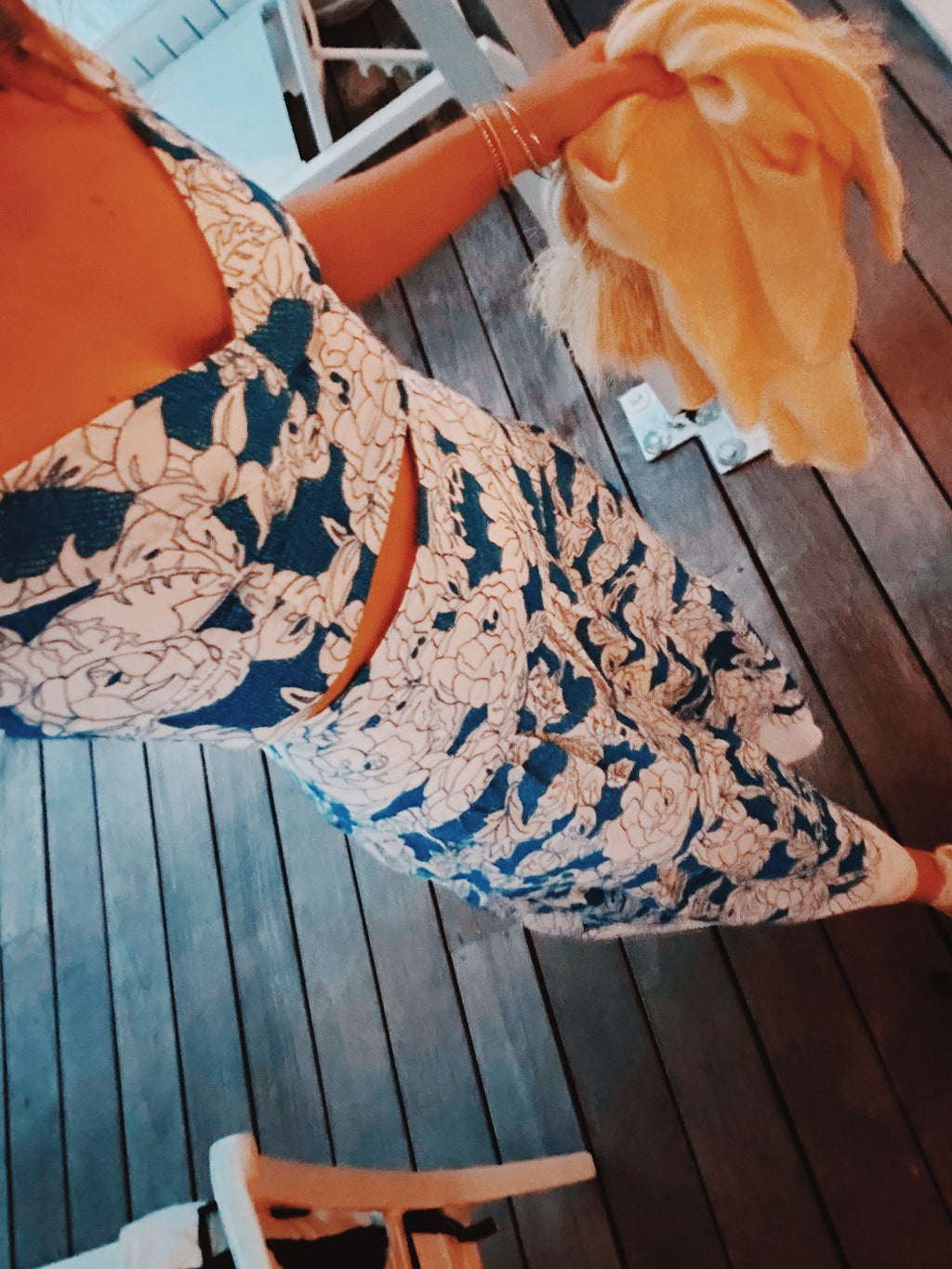 A printed blue and orange skirt on a wooden deck