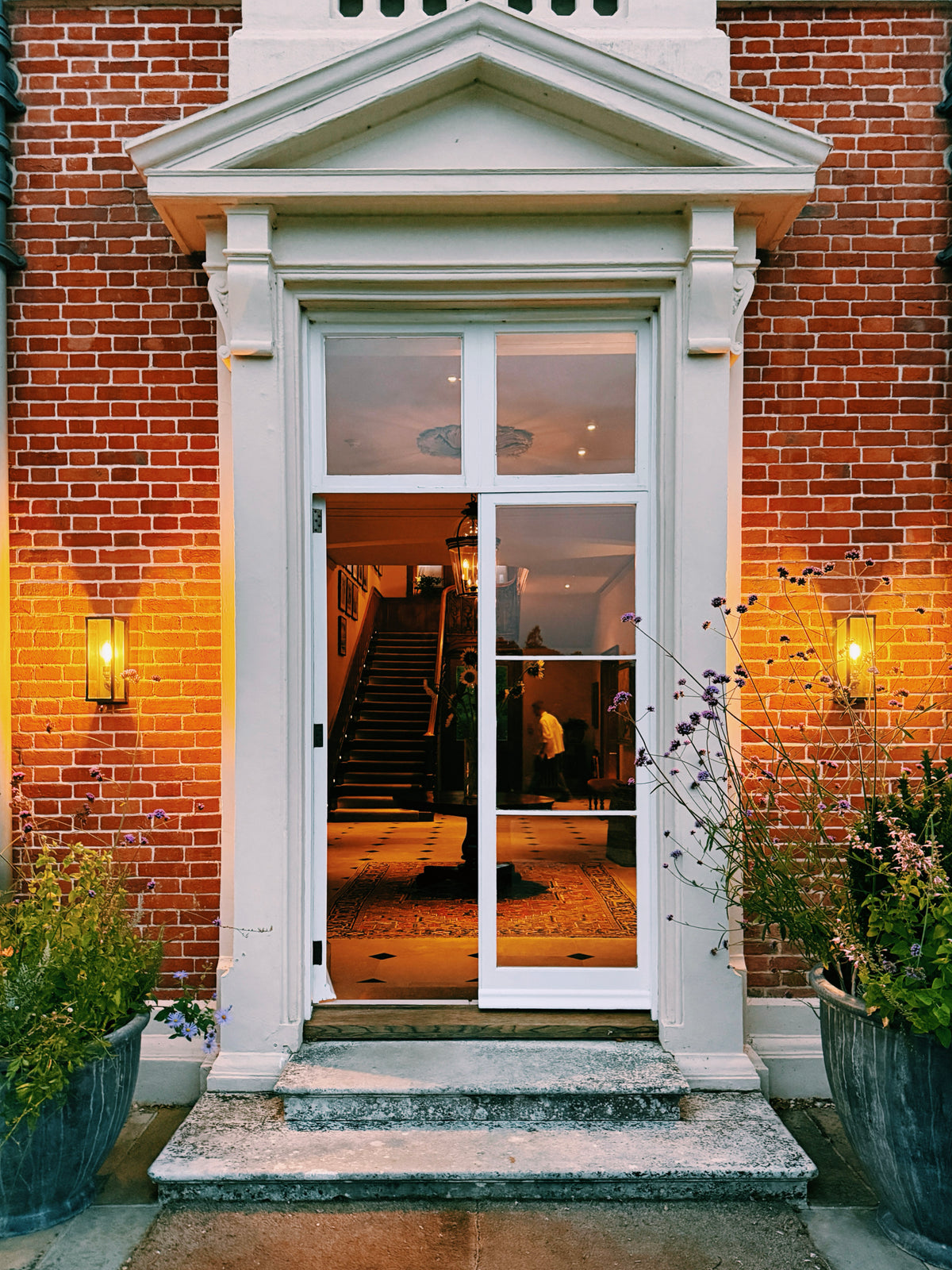 The front door at Heckfield, lanterns lit either side