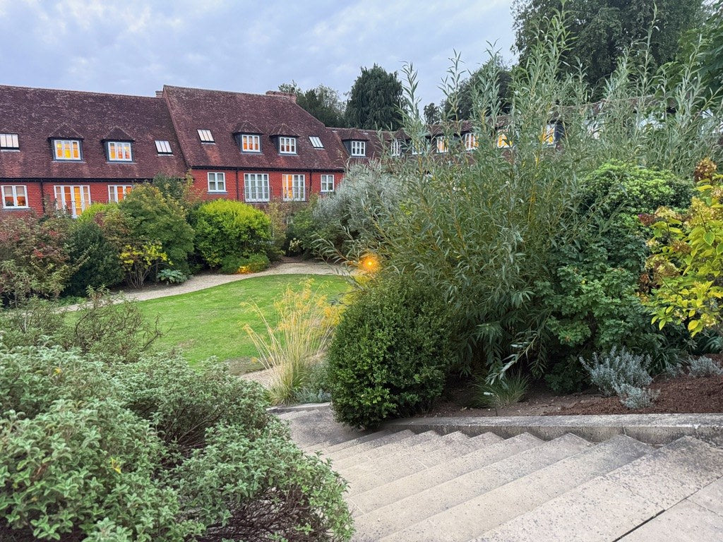 The brick wings of the house above the gardens