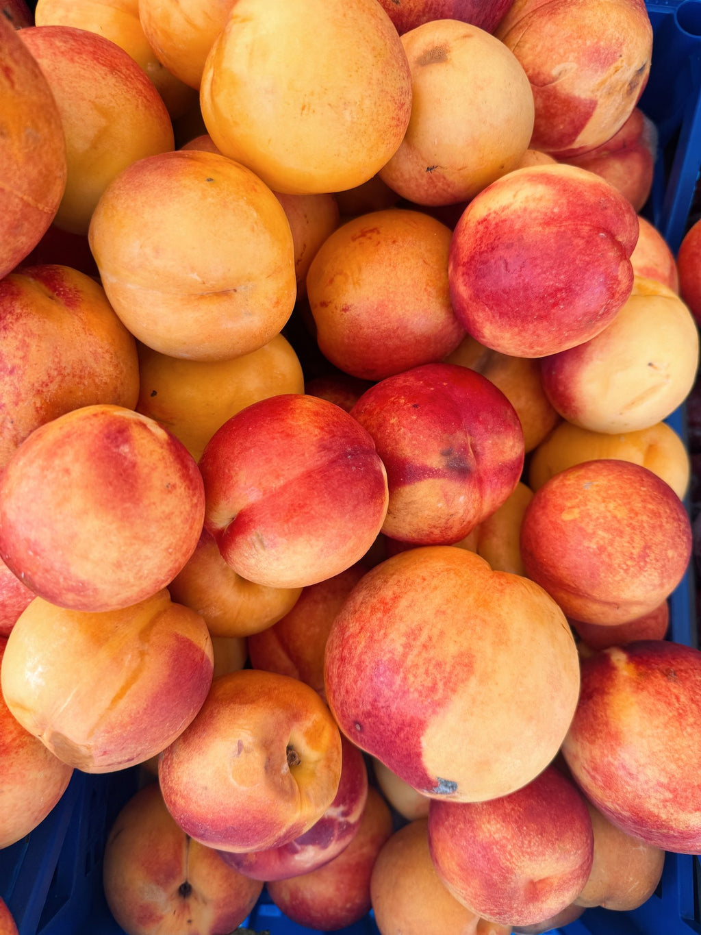 A crate of peaches at the market