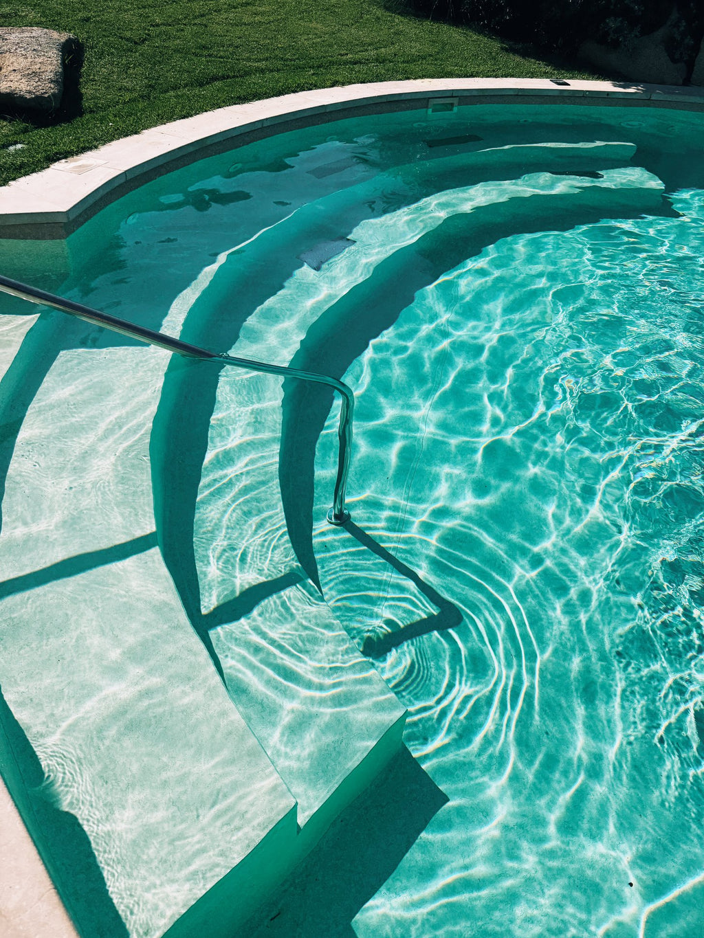 Steps into a clear turquoise pool
