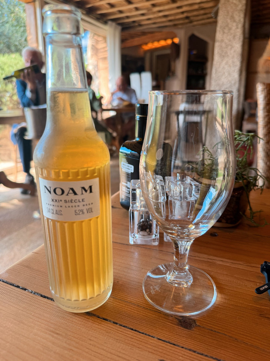 A cold bottle and a glass at a beach bar