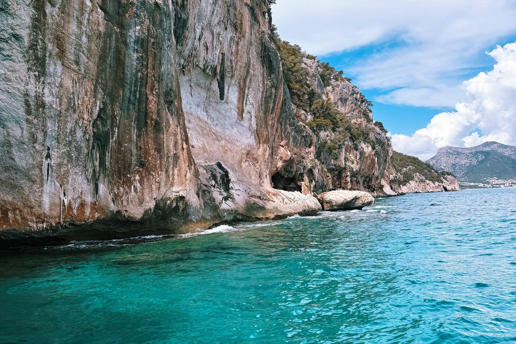 Turquoise water beneath limestone cliffs on the Gulf of Orosei