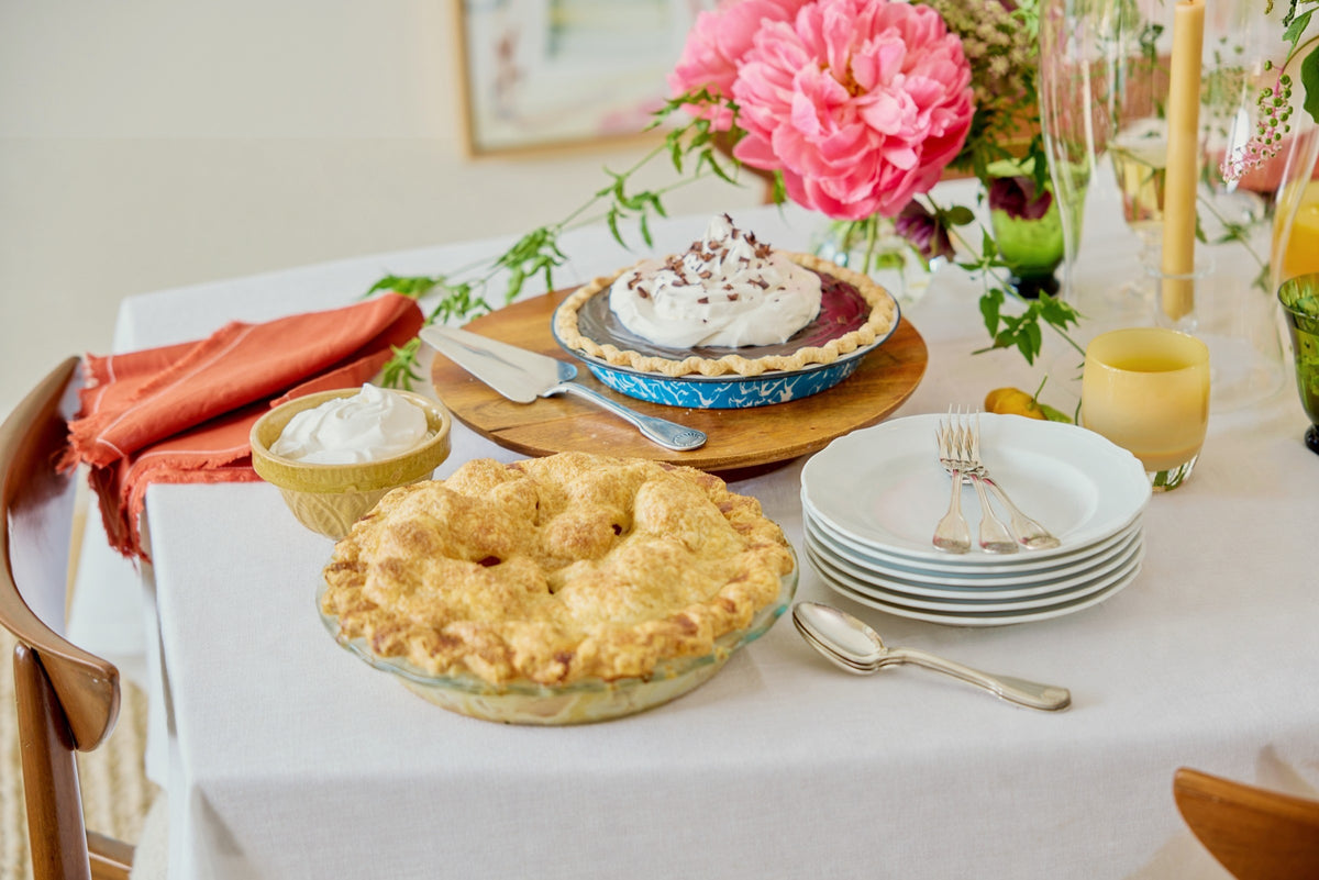 Pies out on Wednesday night, plates stacked, tapers and peonies