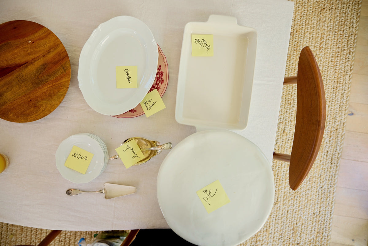 Serving dishes on the sideboard, each with a slip naming the food