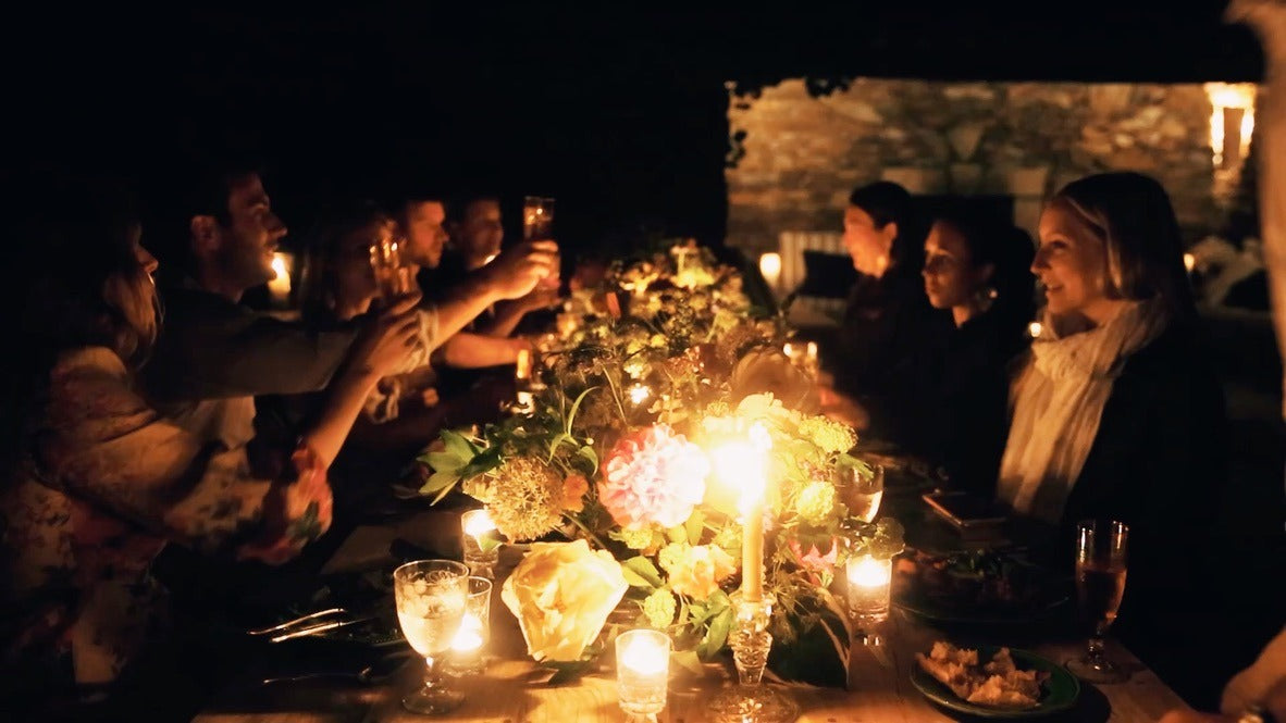 A toast around the candlelit table, late at night